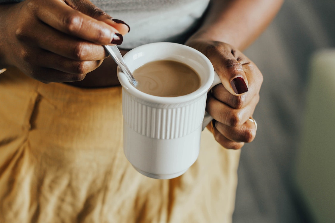 Hands holding a warm mug, a quiet pause